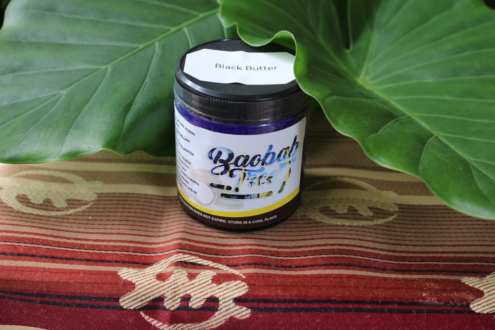 Small herbal supplement jar on a patterned cloth, framed by large green leaves.