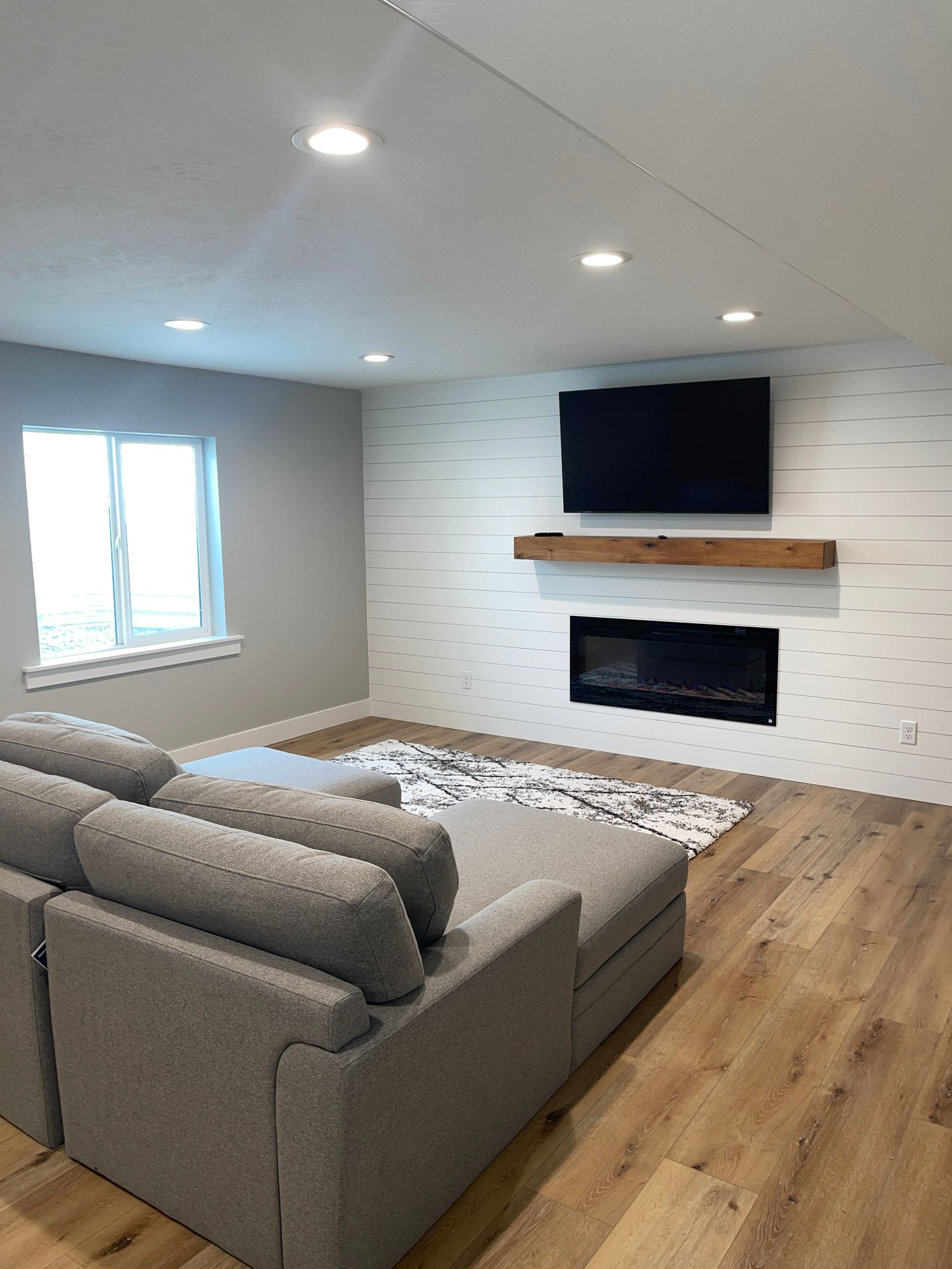 TV above wooden mantel