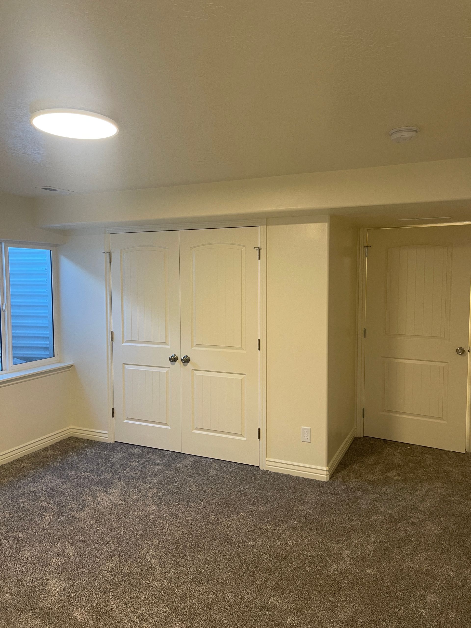 There is a window in the corner of the room.