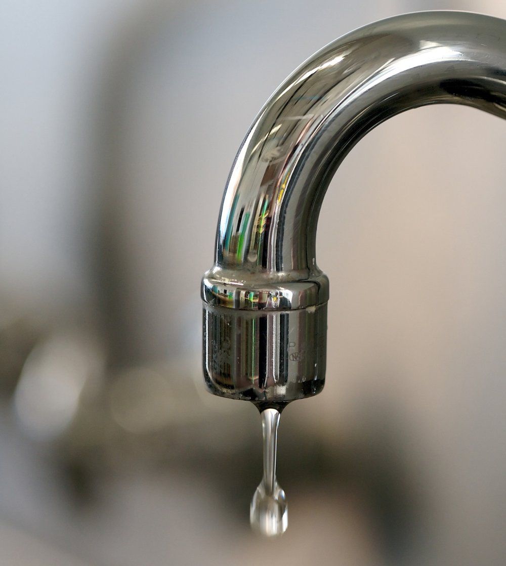 a water tap dripping a few drops of water