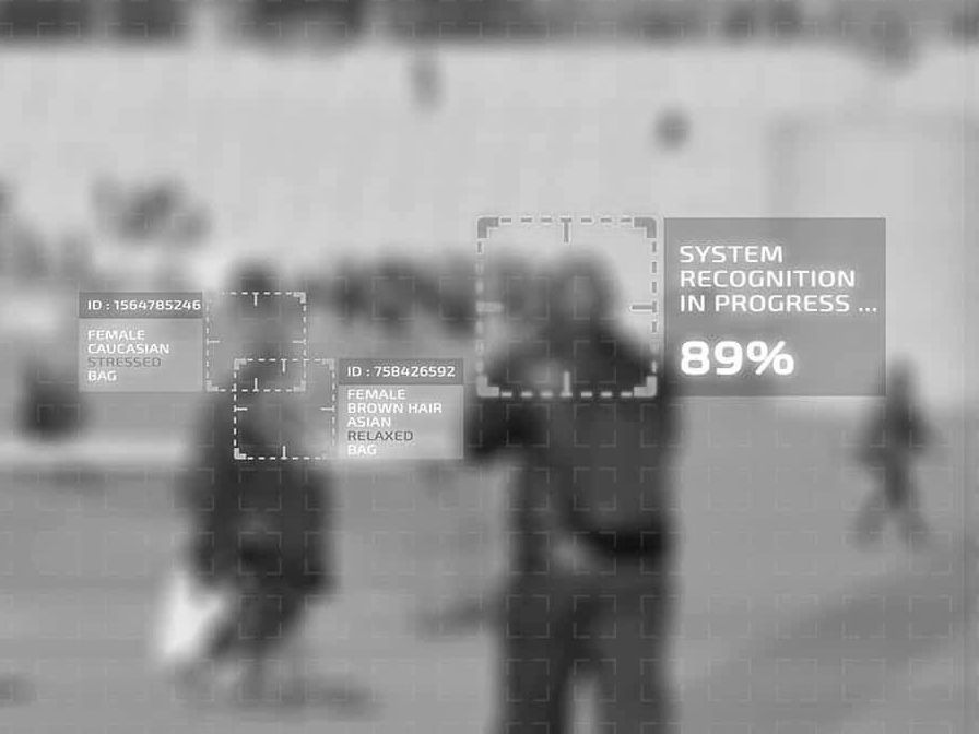 Blurred street scene with people and overlay text reading “System in progress 89%”
