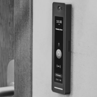 Wall-mounted black touchscreen access panel beside a door, showing 10:30 and a lock icon.