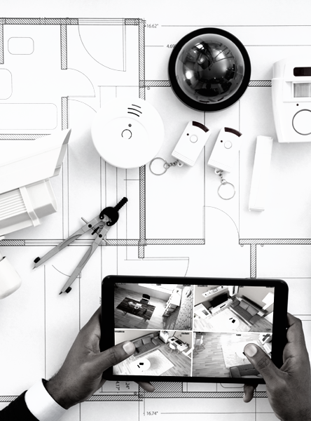 Tablet displaying a home floor plan with security devices and hands holding stylus and tablet