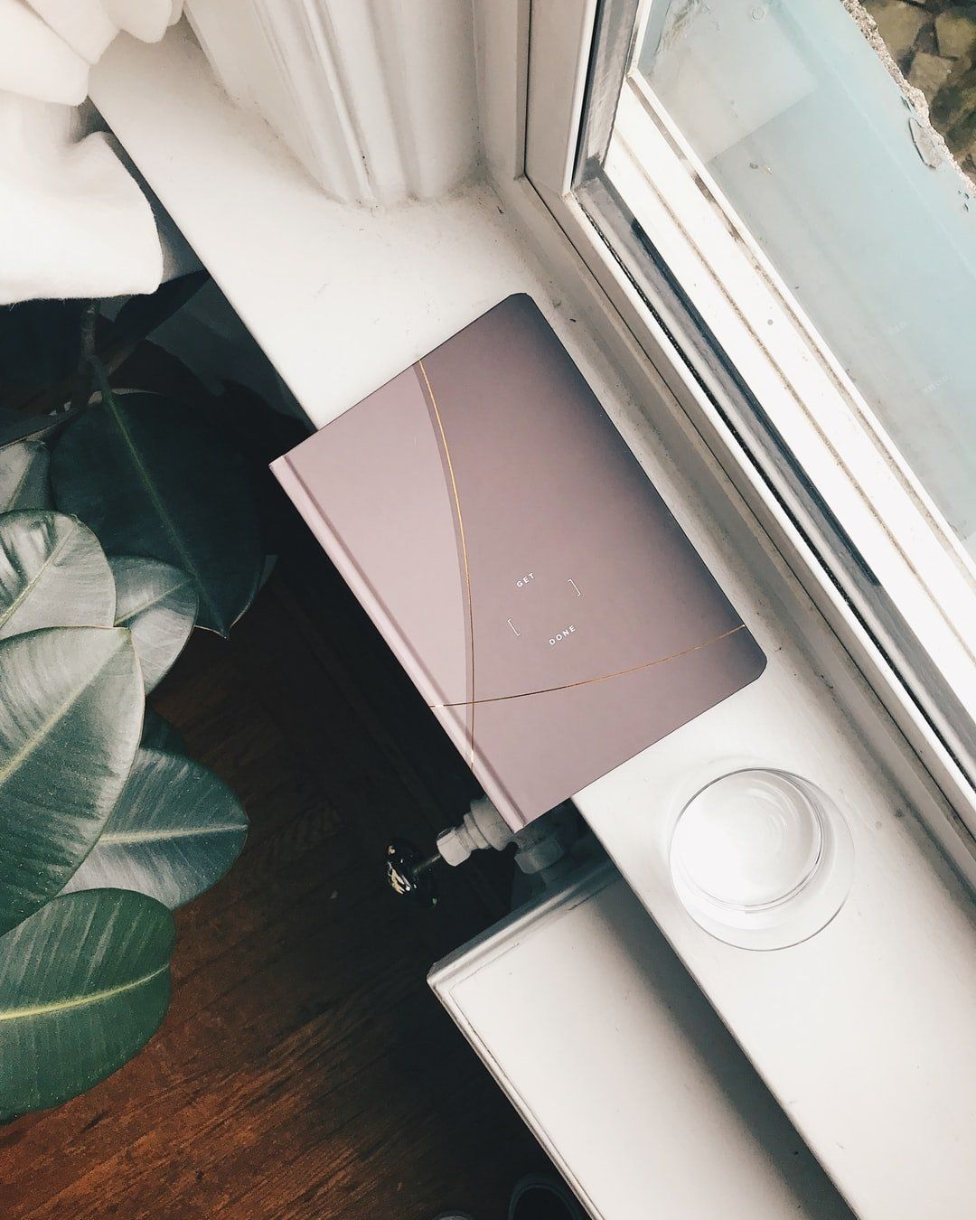 GK Marketing Online | A book sits on a window sill next to a plant