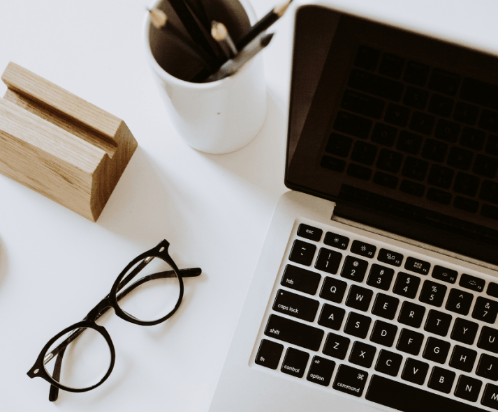 GK Marketing Online | A laptop is open on a desk next to a pair of glasses