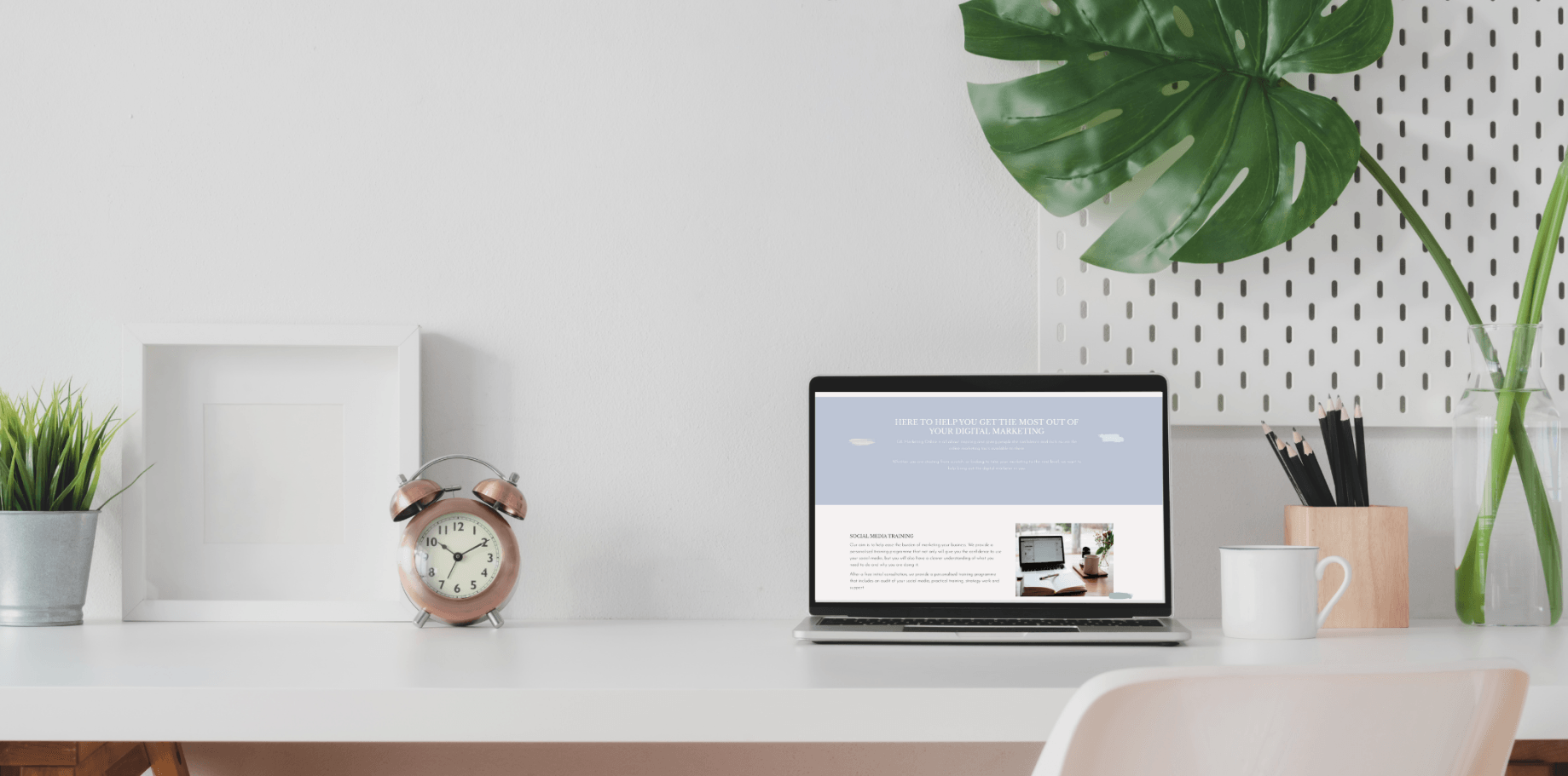 GK Marketing Online | A laptop computer is sitting on a desk next to an alarm clock.