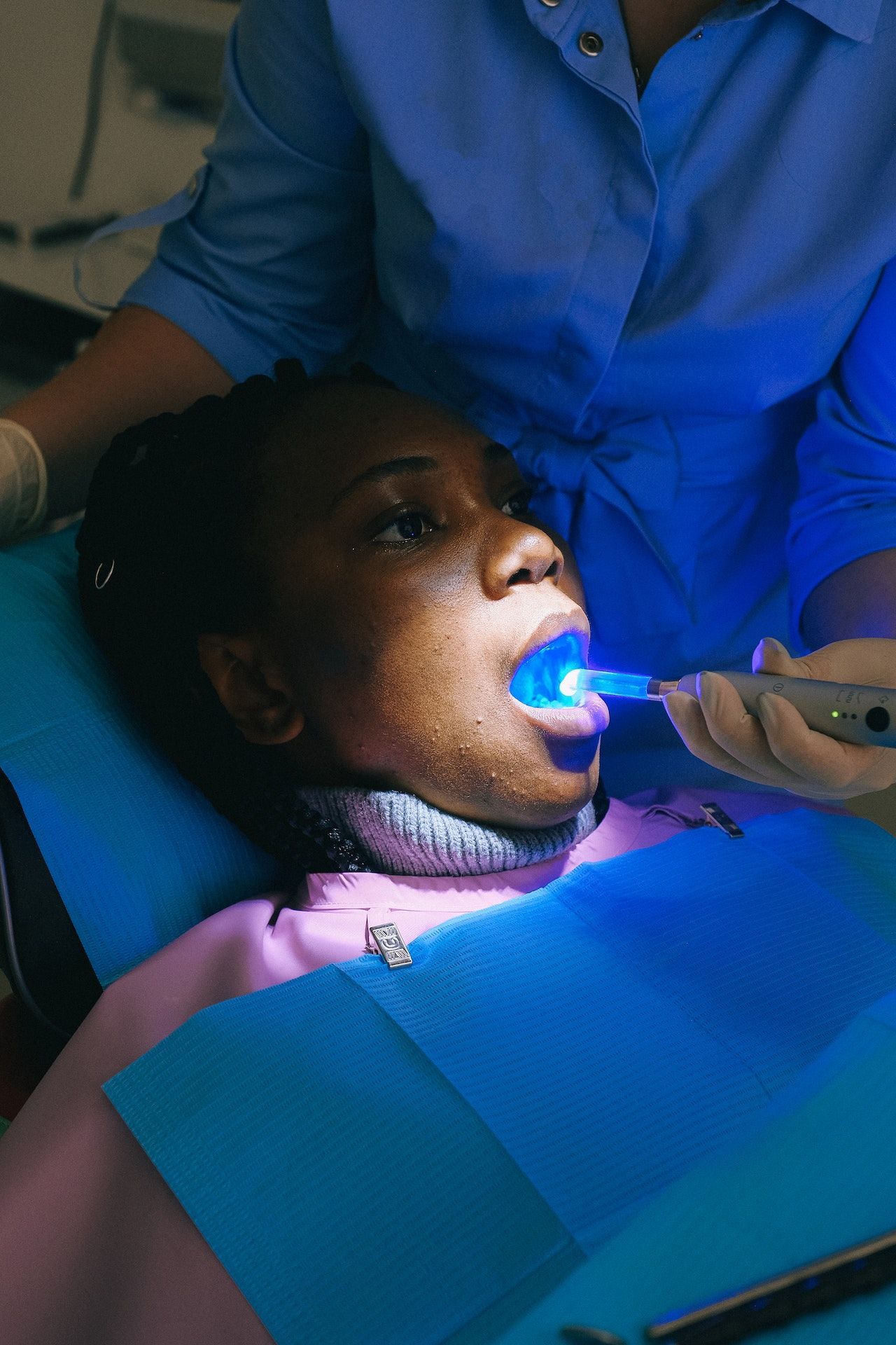 Get dental bonding in Oak Point 75068. Patient taking a dental exam