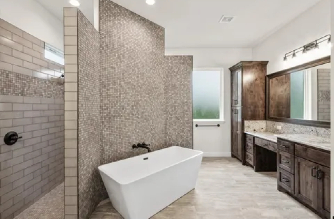 Modern bathroom with freestanding tub, walk-in shower, double vanity, and large mirrors