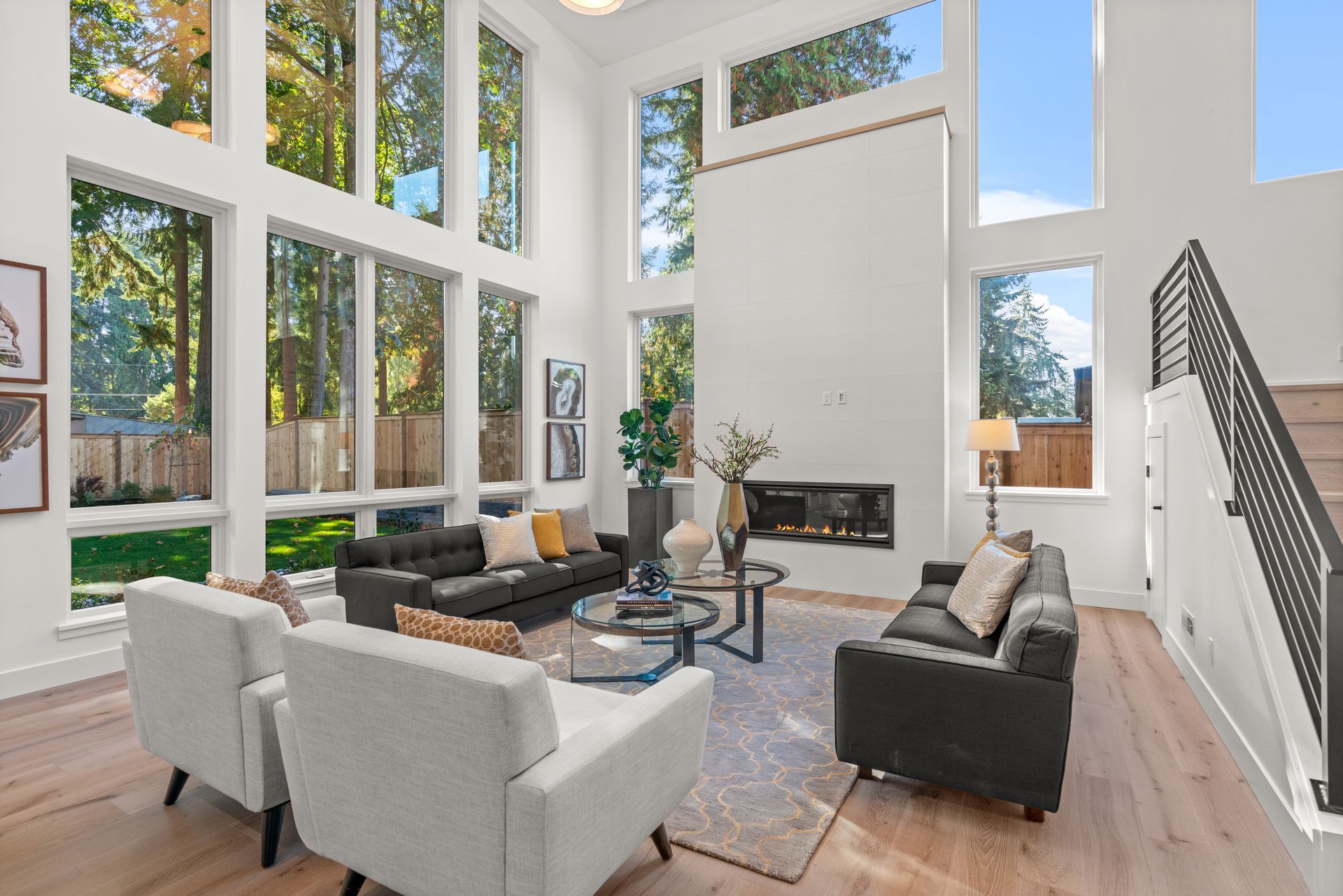 It is a living room with a lot of windows and a fireplace.