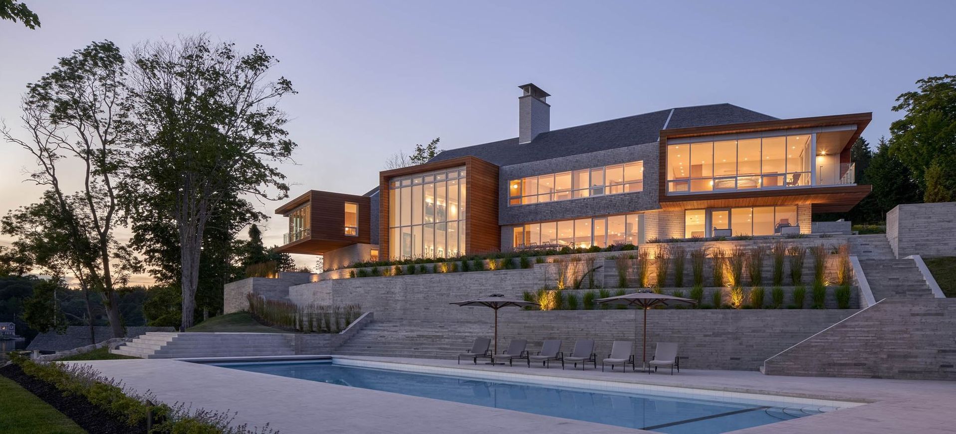 A large house with a swimming pool in front of it.