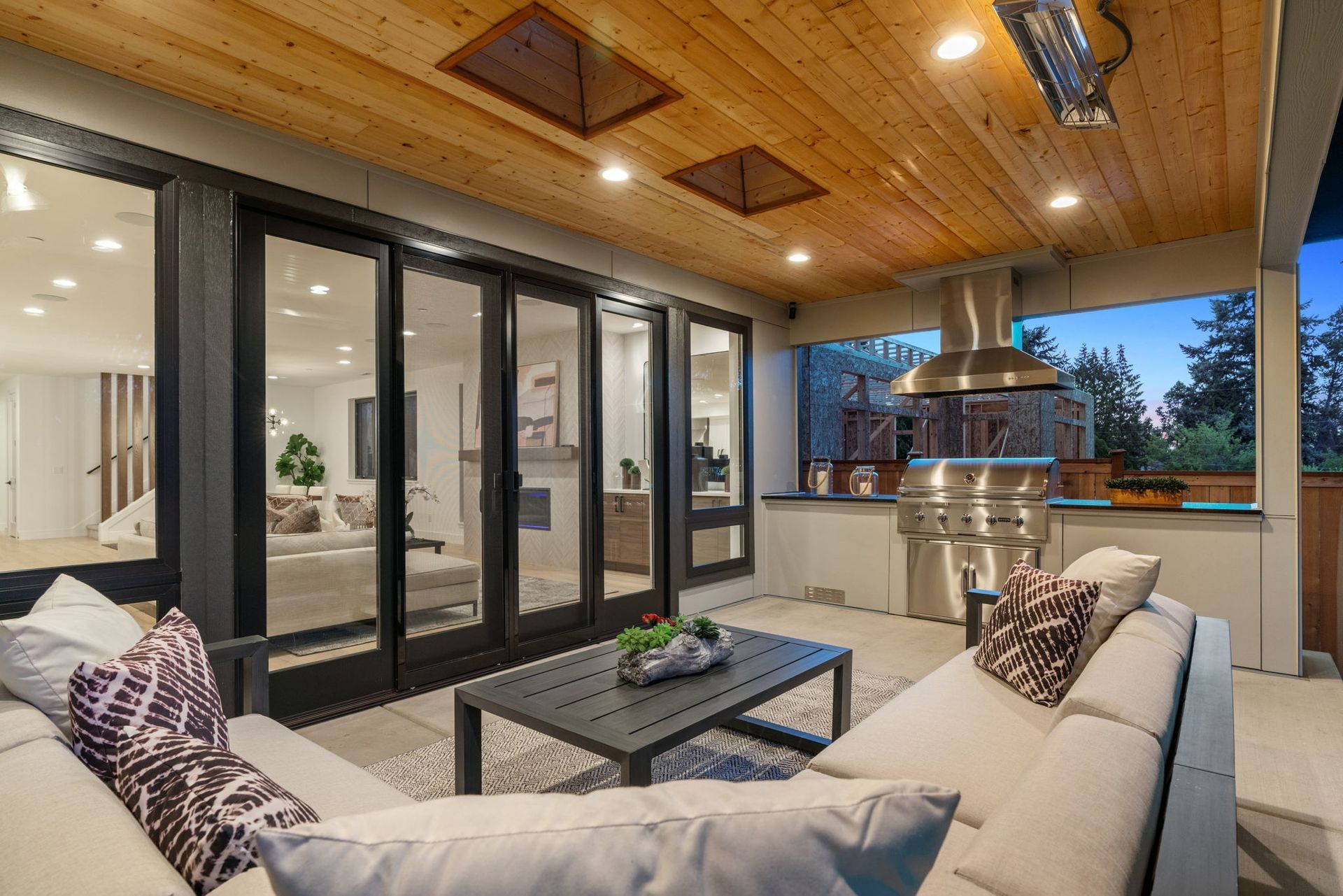 A living room with a couch , table , and sliding glass doors.