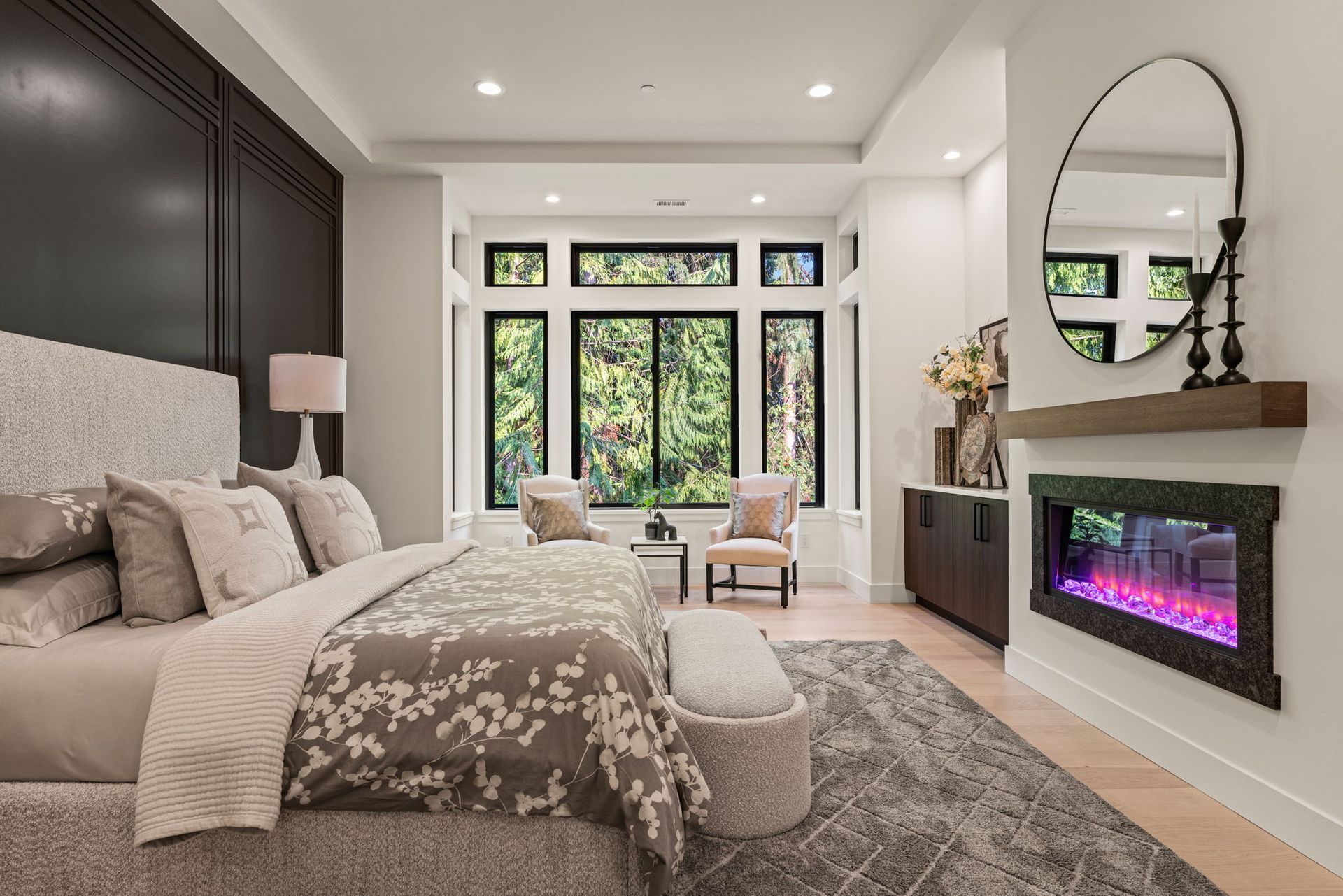 Spacious living room with high ceilings, neutral tones, and modern furnishings, connected to kitchen and dining area.