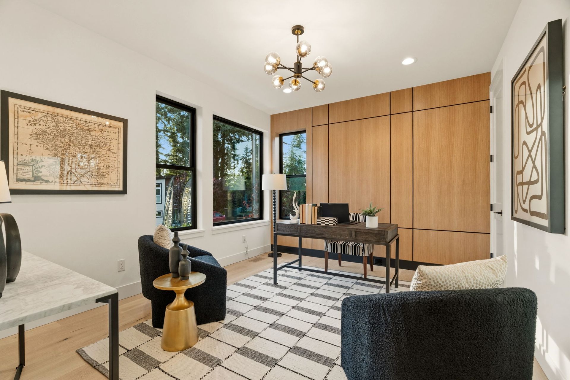 Modern house entryway with concrete steps, wood ceiling, glass door, and green shrubs