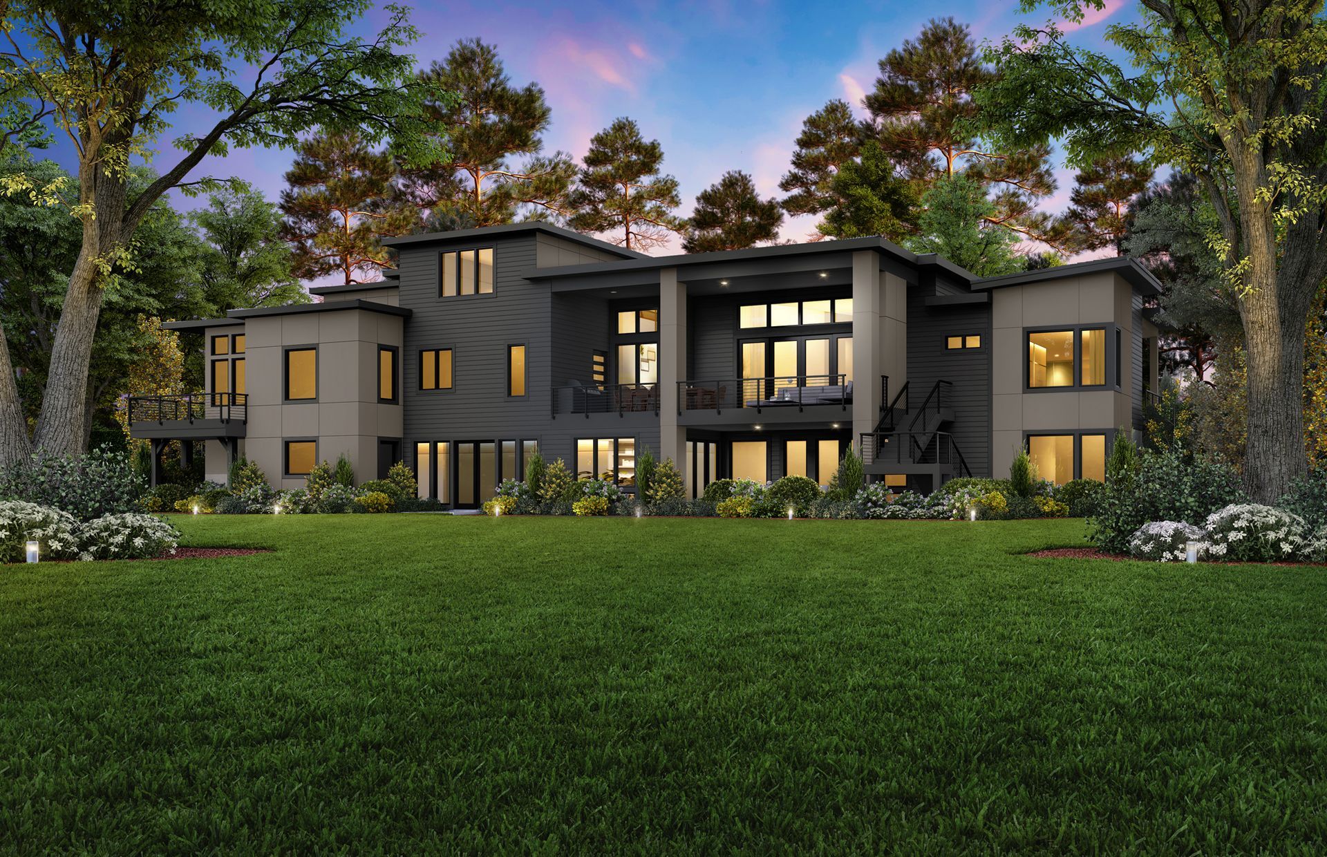 A large house with a lush green lawn surrounded by trees.
