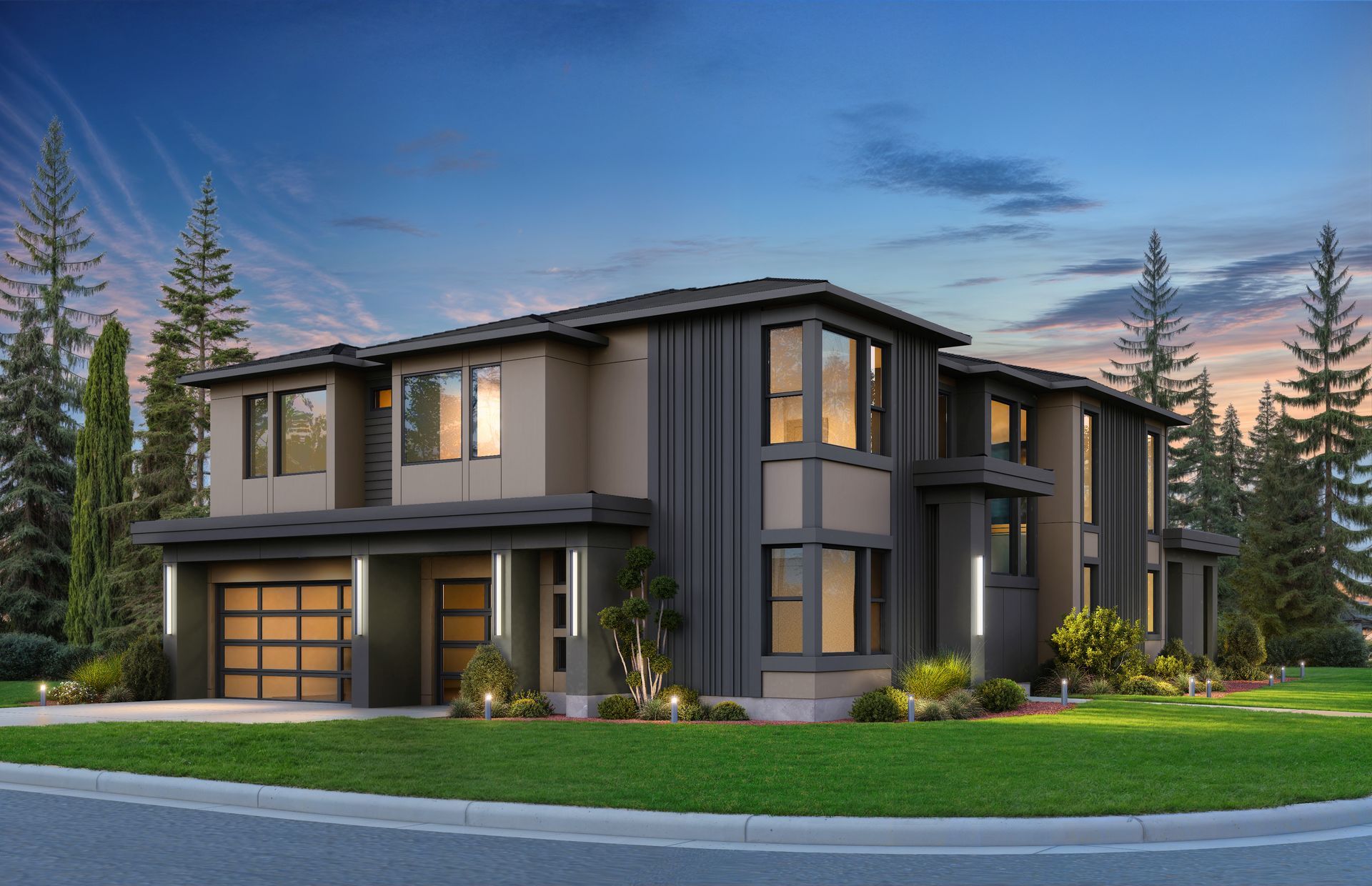 Modern two-story gray house with warm lit windows at dusk, surrounded by trees and a green lawn