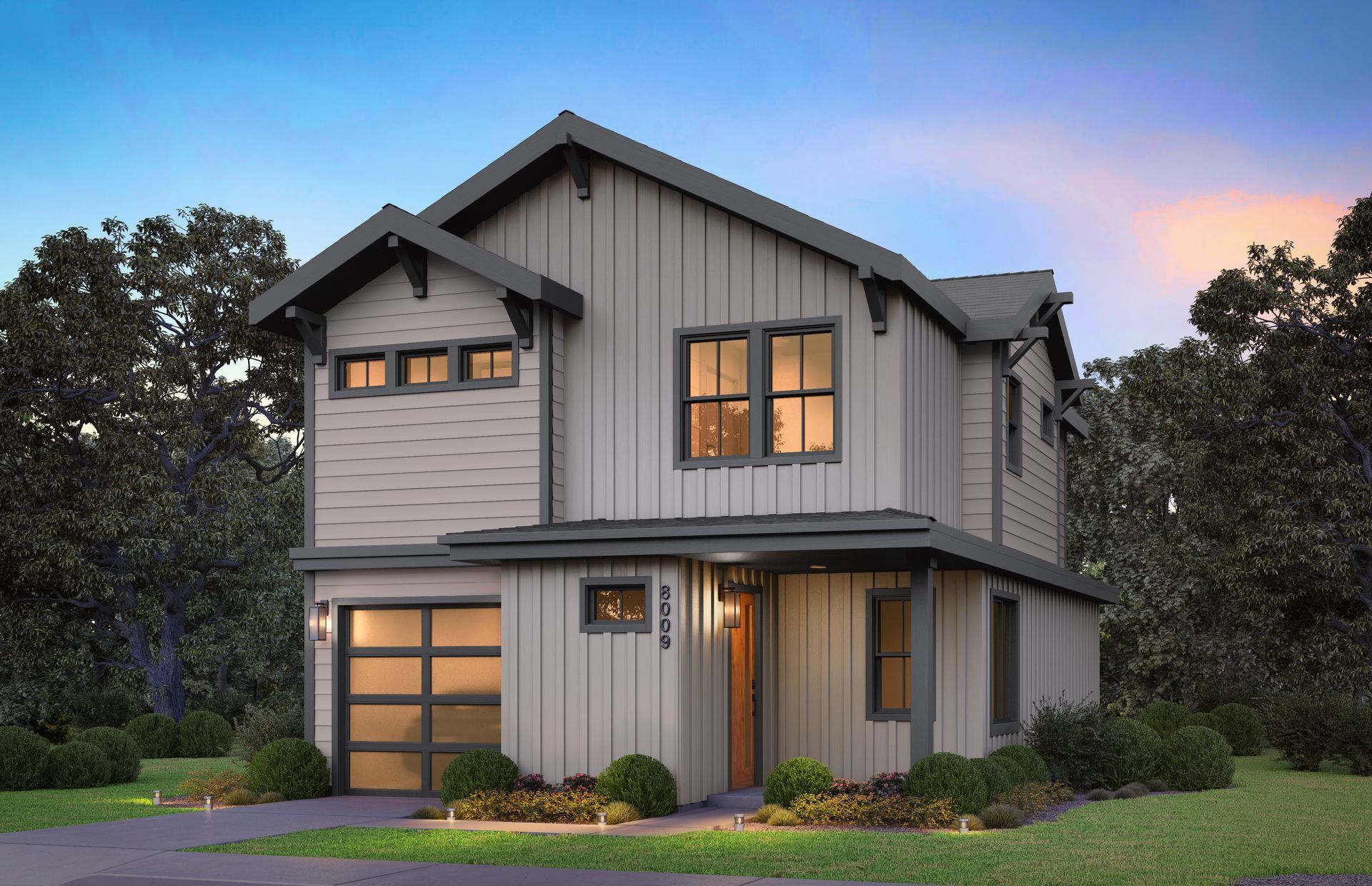 Two-story modern house with grey siding, a garage, and a wooden door; nestled in a green space.
