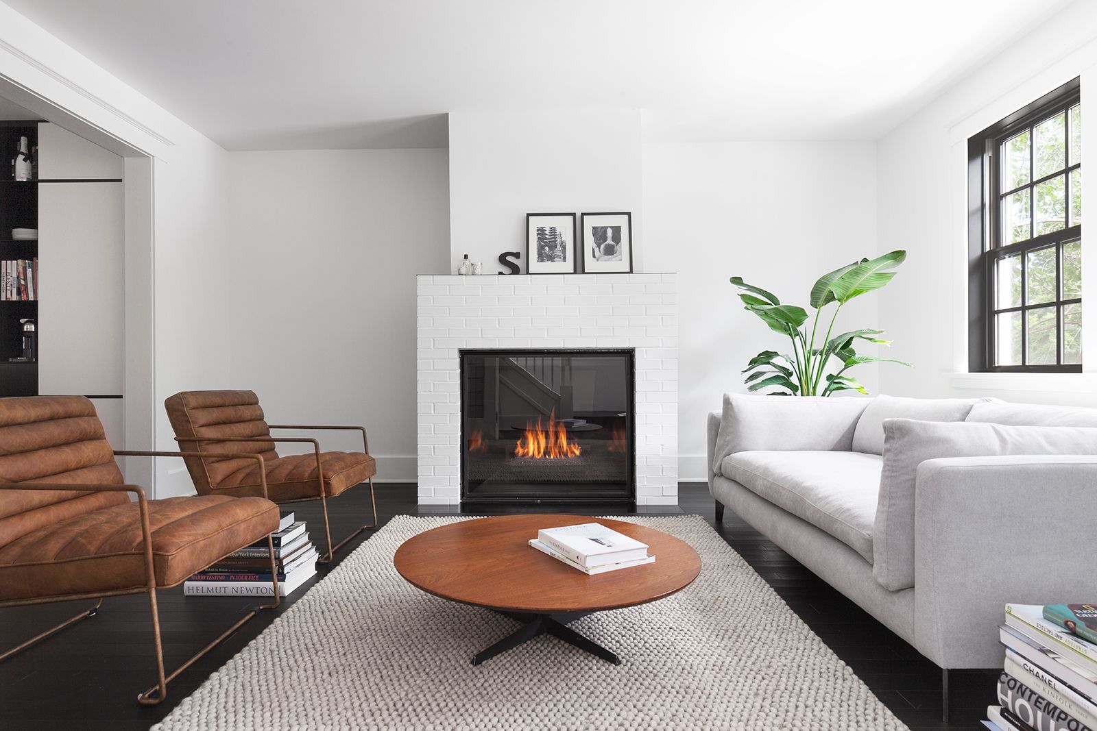 A living room with a couch , chairs , coffee table and fireplace.