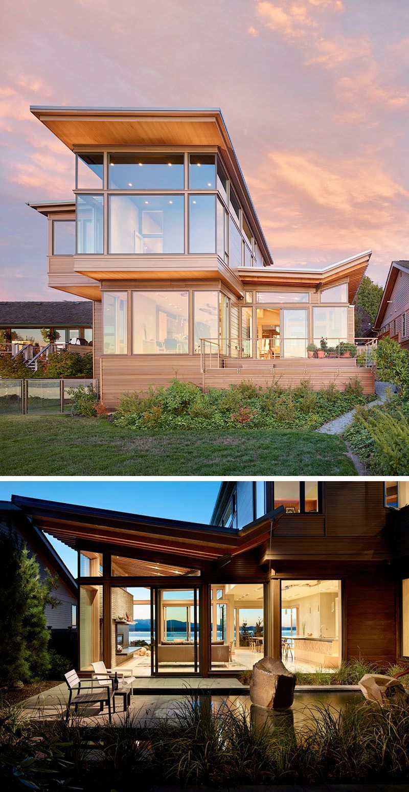 A modern house with a lot of windows and a large roof.