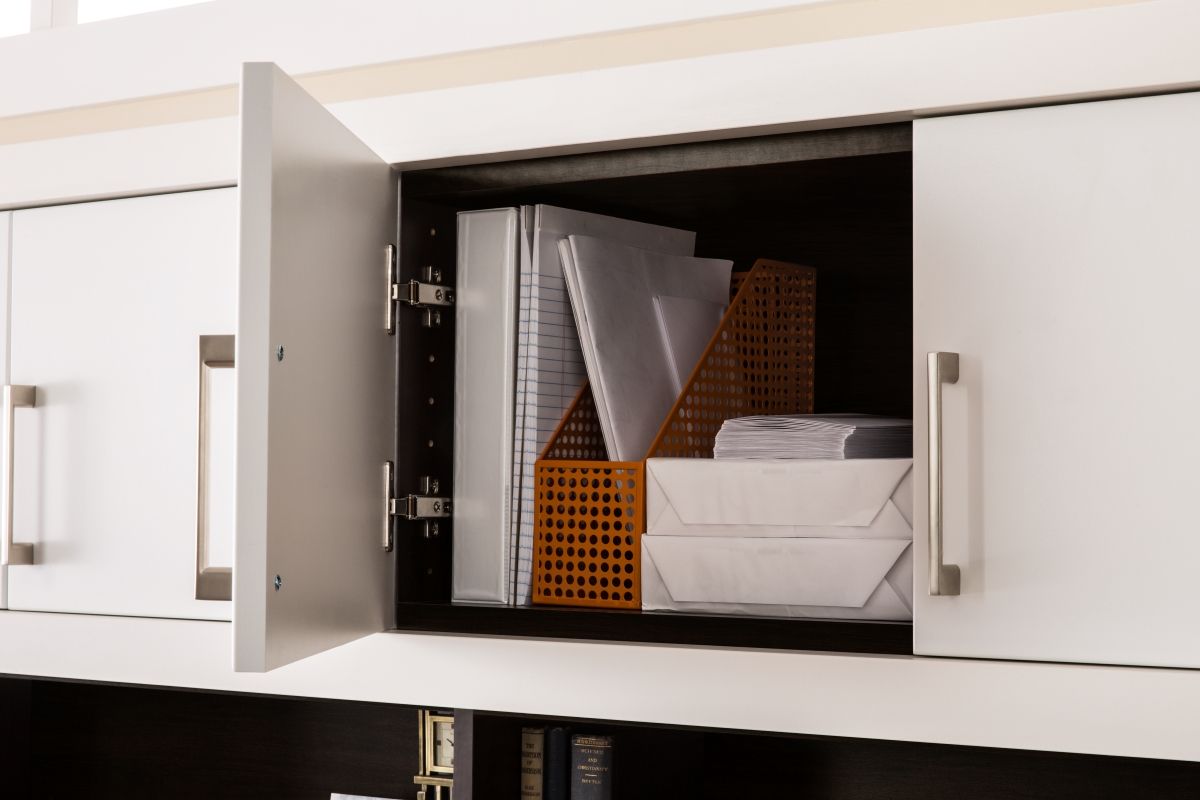 A cabinet with a bunch of papers in it