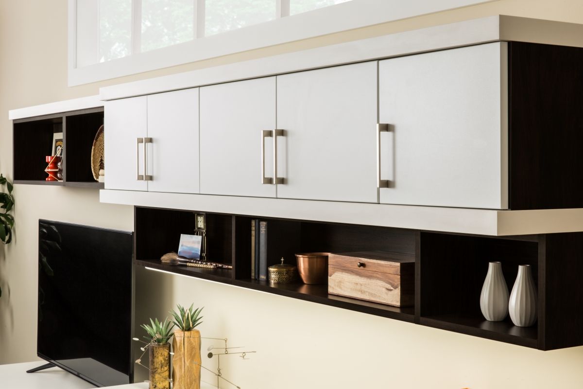 A living room with white cabinets and a flat screen tv