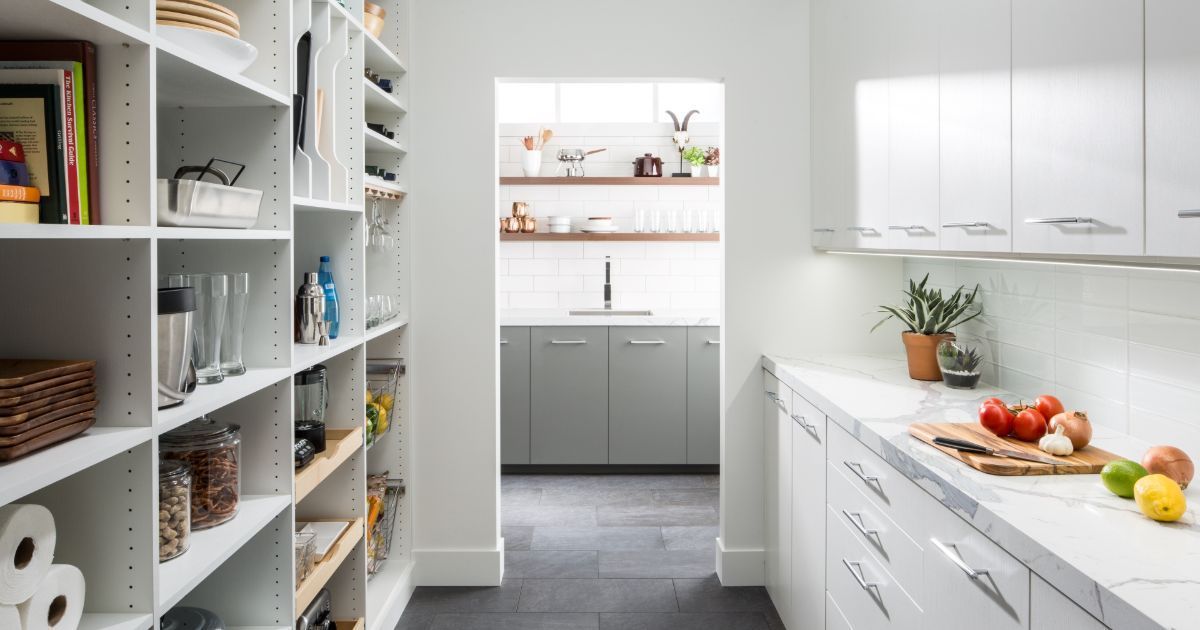 A kitchen with white cabinets and a pantry filled with lots of food.