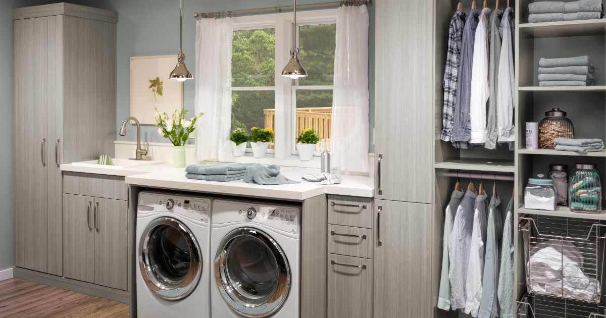 A laundry room with a washer and dryer and a sink.