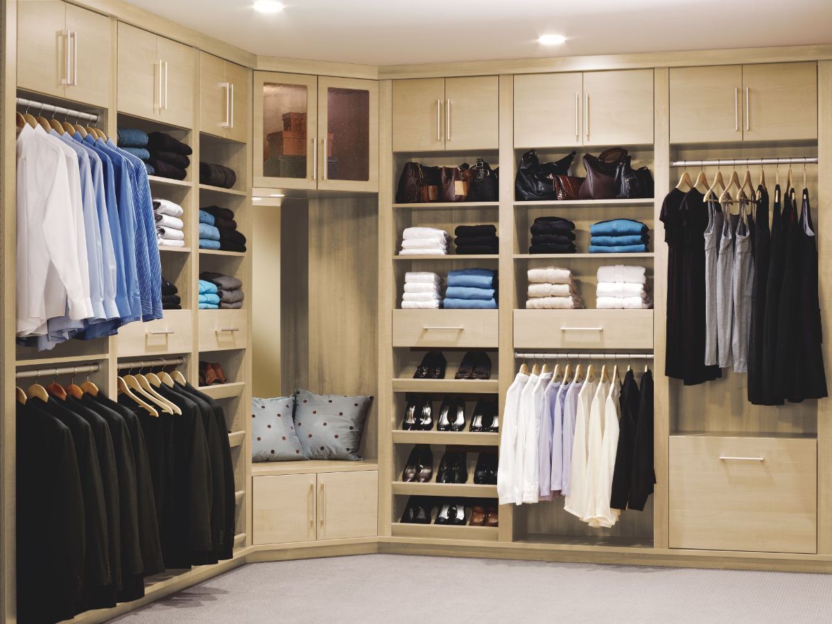 A walk in closet filled with clothes and shoes