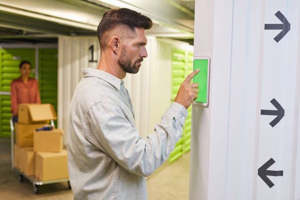 Mini storage user operating keypad to open self storage unit gate.