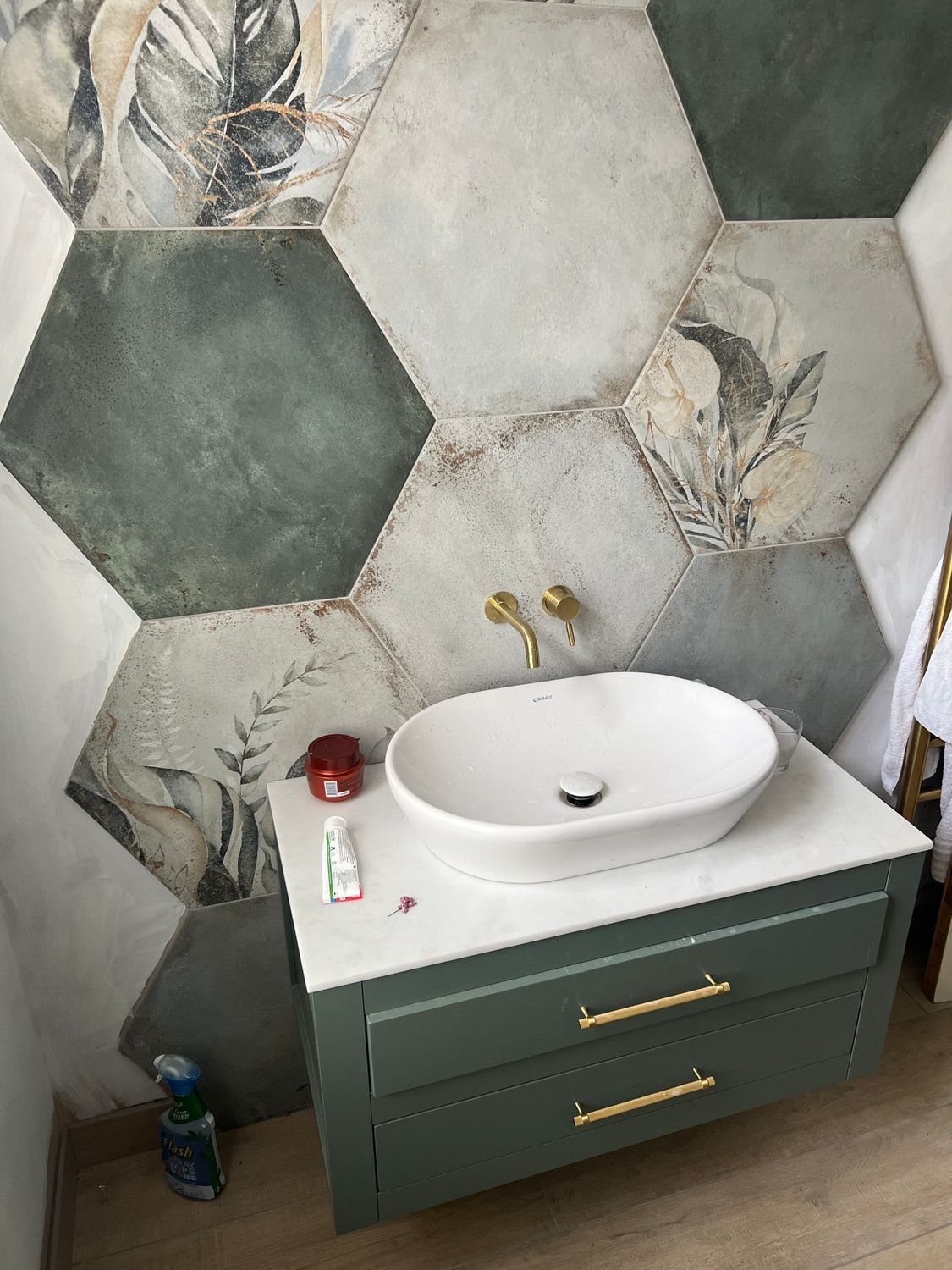 A bathroom with a sink and a toothbrush on the counter.