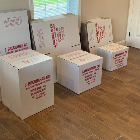 stack of company labelled cardboard moving boxes