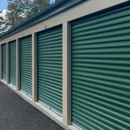 several indoor storage units with green doors