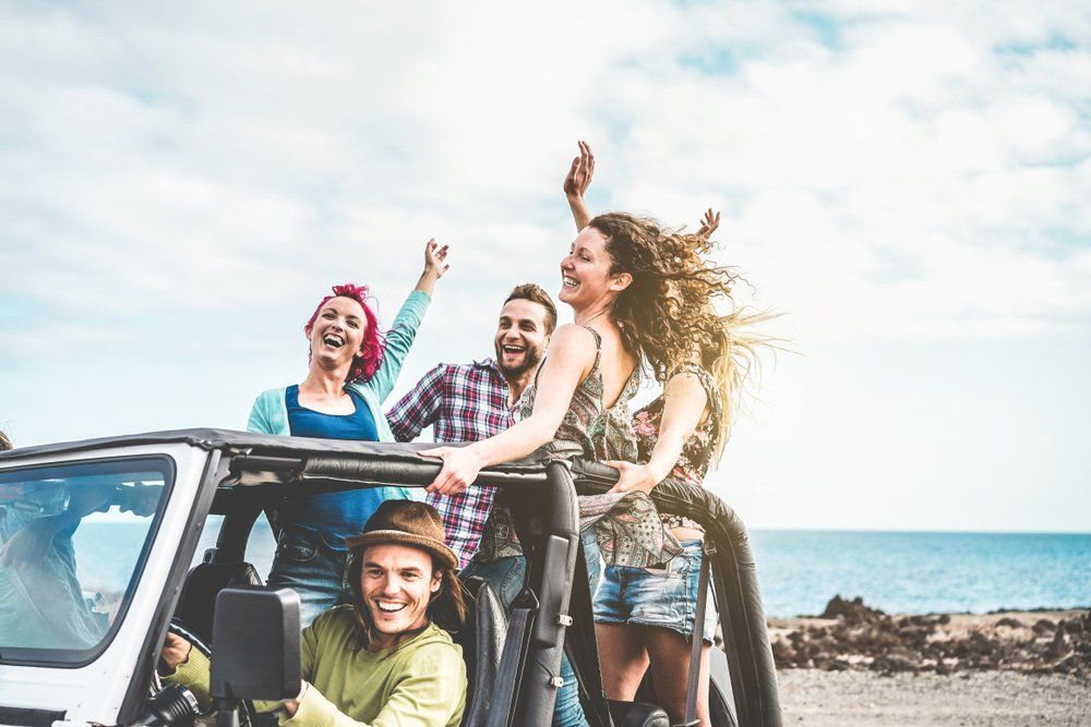 A group of young hotel social media influencers having fun at the beach