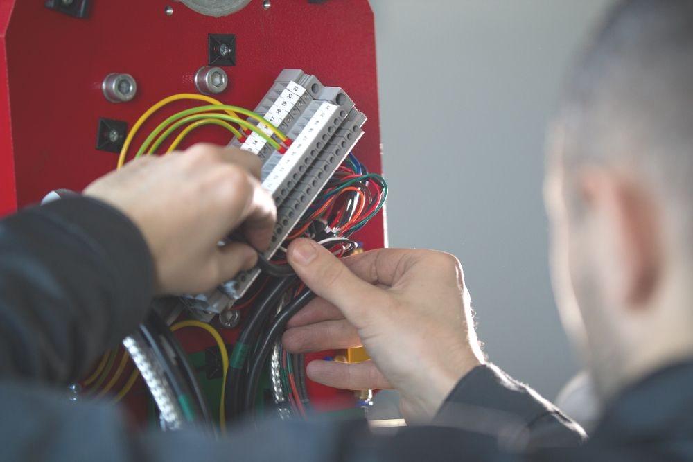 Person Wiring Electrical Components — Fire Maintenance Services (NT) Pty Ltd in Winnellie, NT