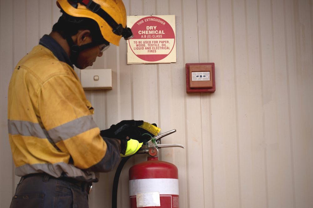 Worker in Yellow Uniform and Helmet — Fire Maintenance Services (NT) Pty Ltd in Winnellie, NT