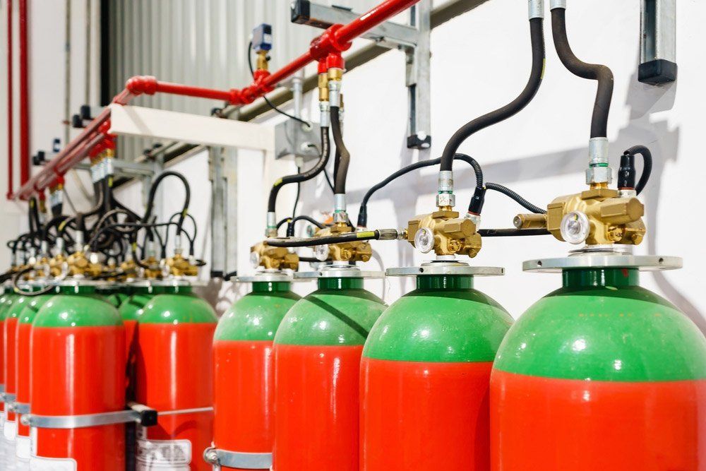 Rows of Red and Green Fire Suppression Gas Cylinders — Fire Maintenance Services (NT) Pty Ltd in Winnellie, NT