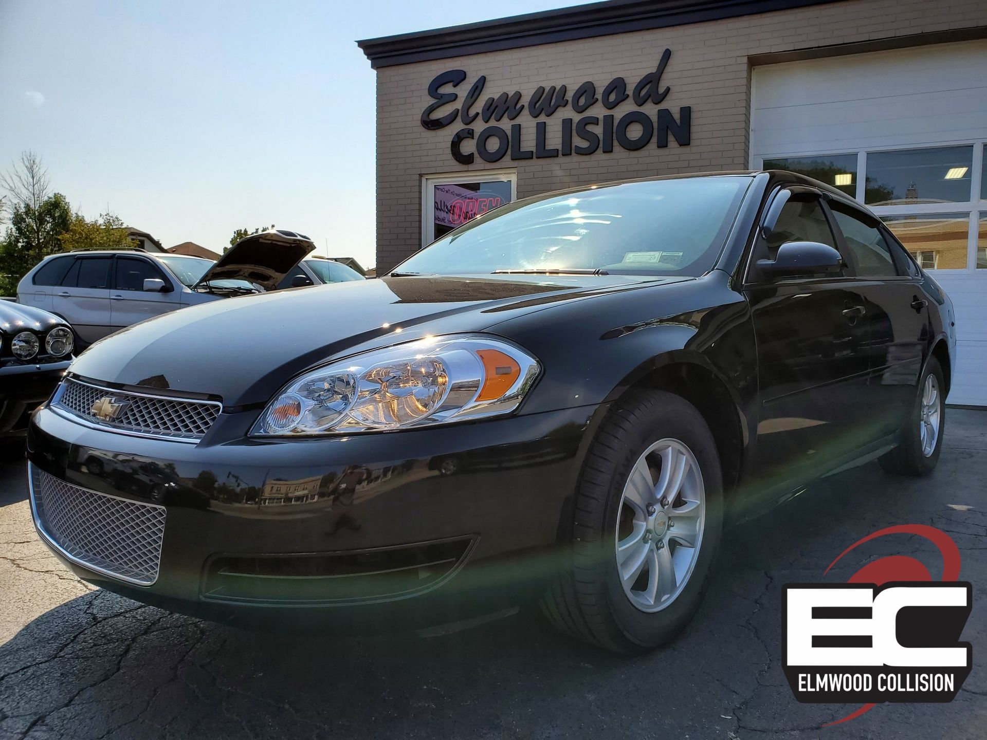 A professionally repaired vehicle by elmwood collision outside in the parking lot.