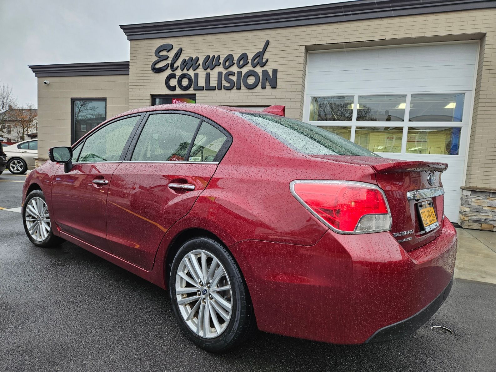 Vehicle completely repaired and parked in front of Elmwood Collision.