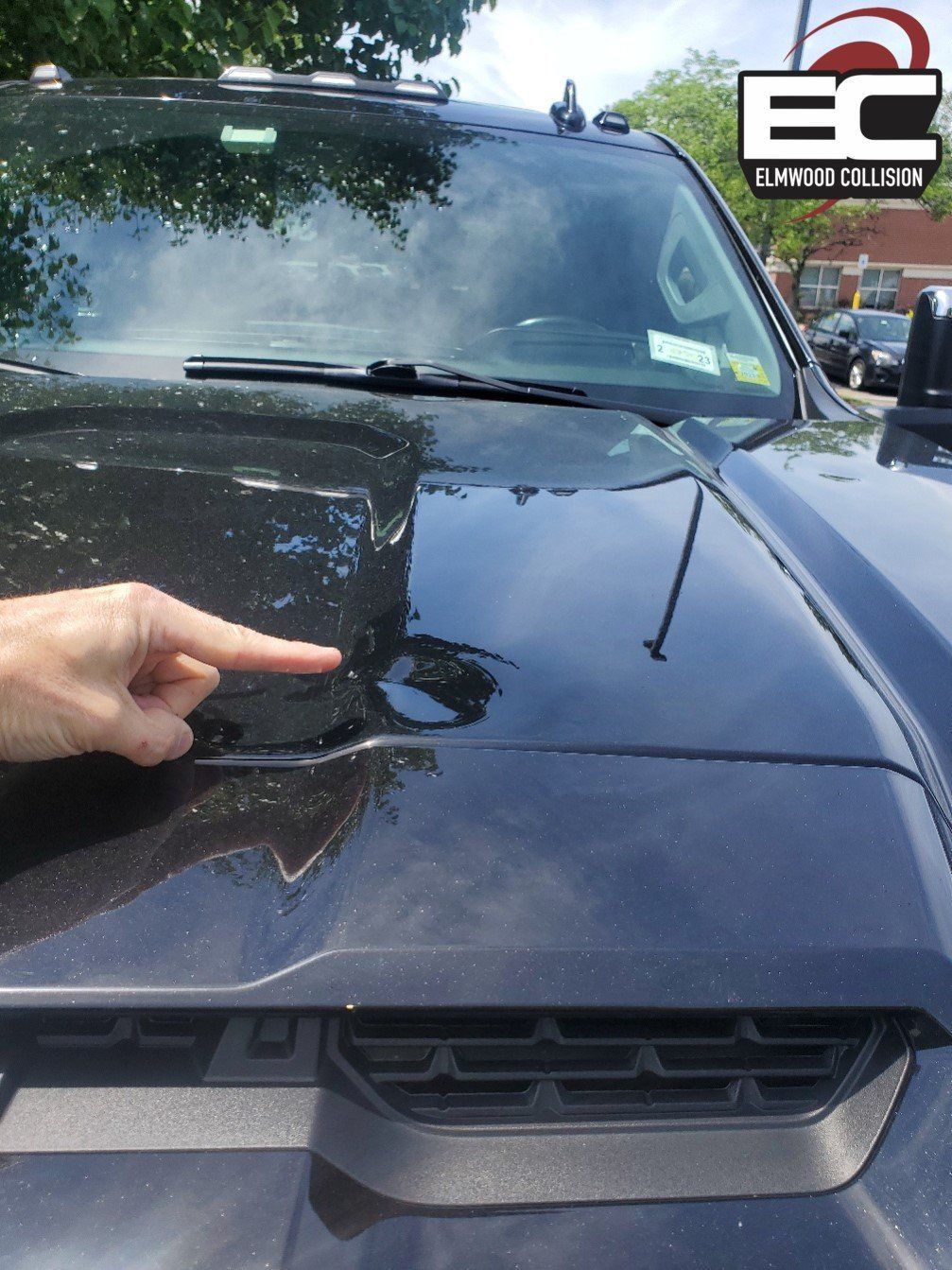 dent in truck hood at elmwood collision