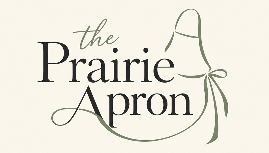 The Prairie Apron logo in black and sage green on a cream background, with a flowing apron outline.