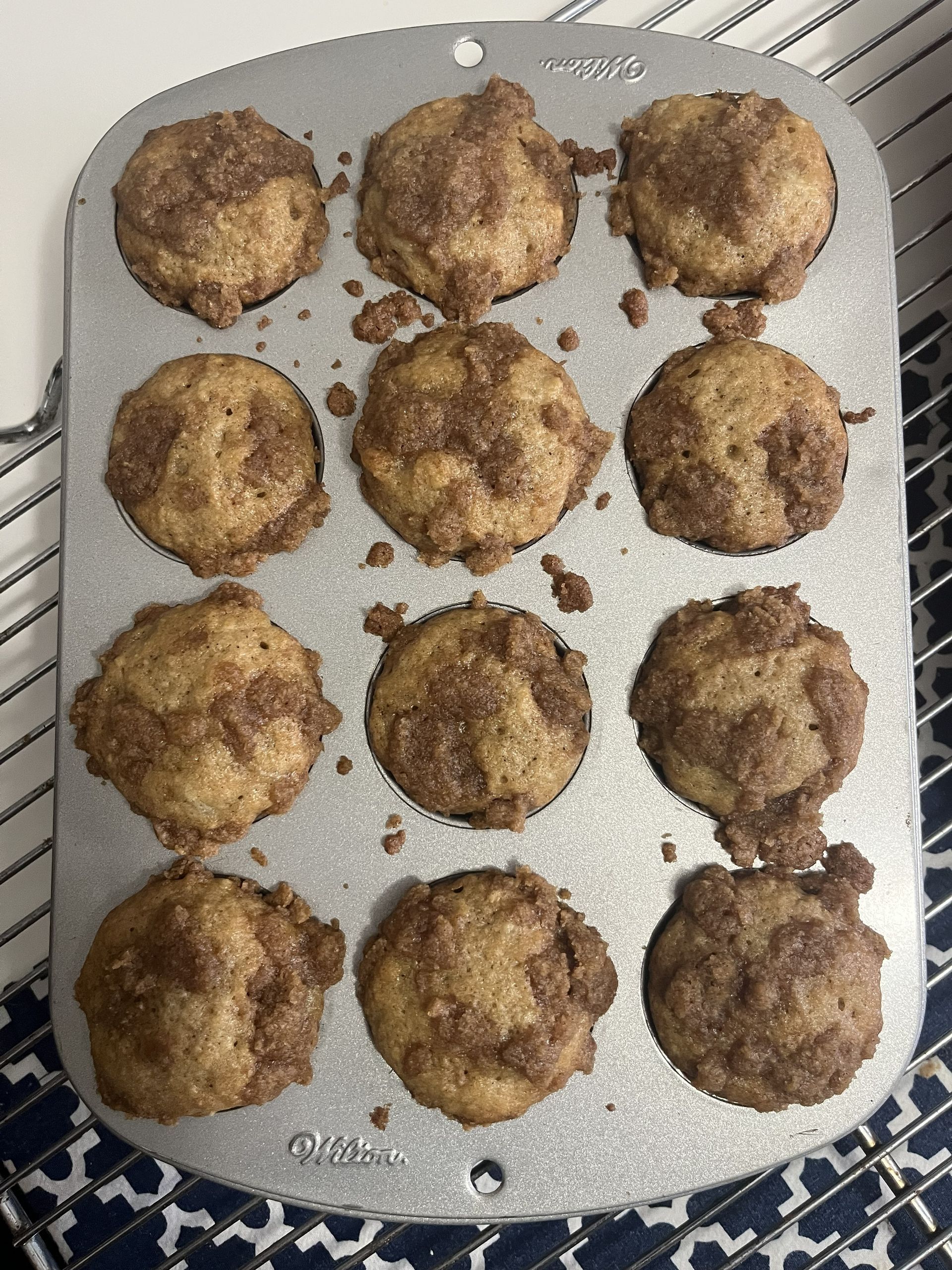 Twelve baked muffins on a silver baking tray, viewed from above.