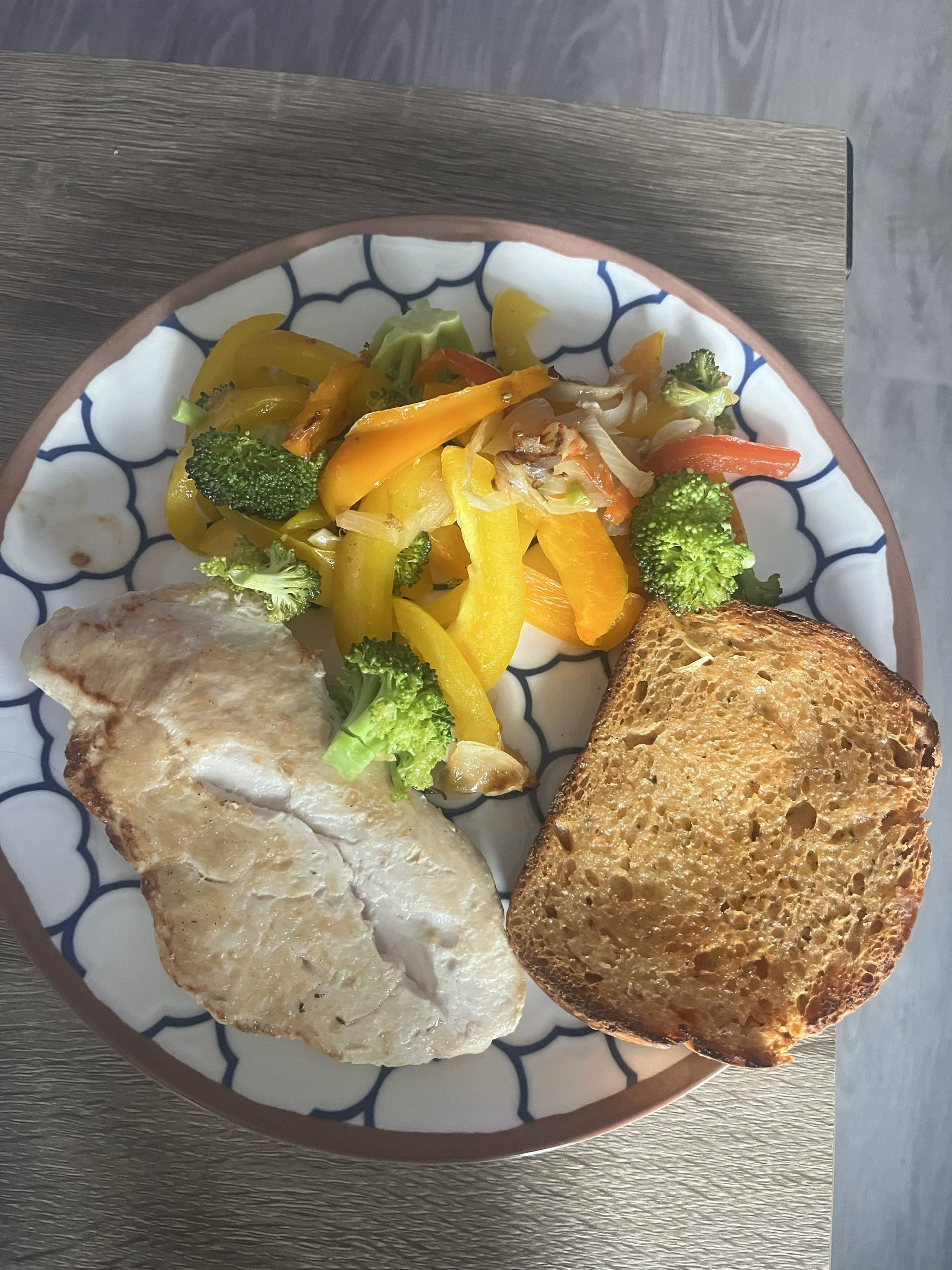 Plate with a breaded cutlet, mashed potatoes, and mixed vegetables on a patterned plate