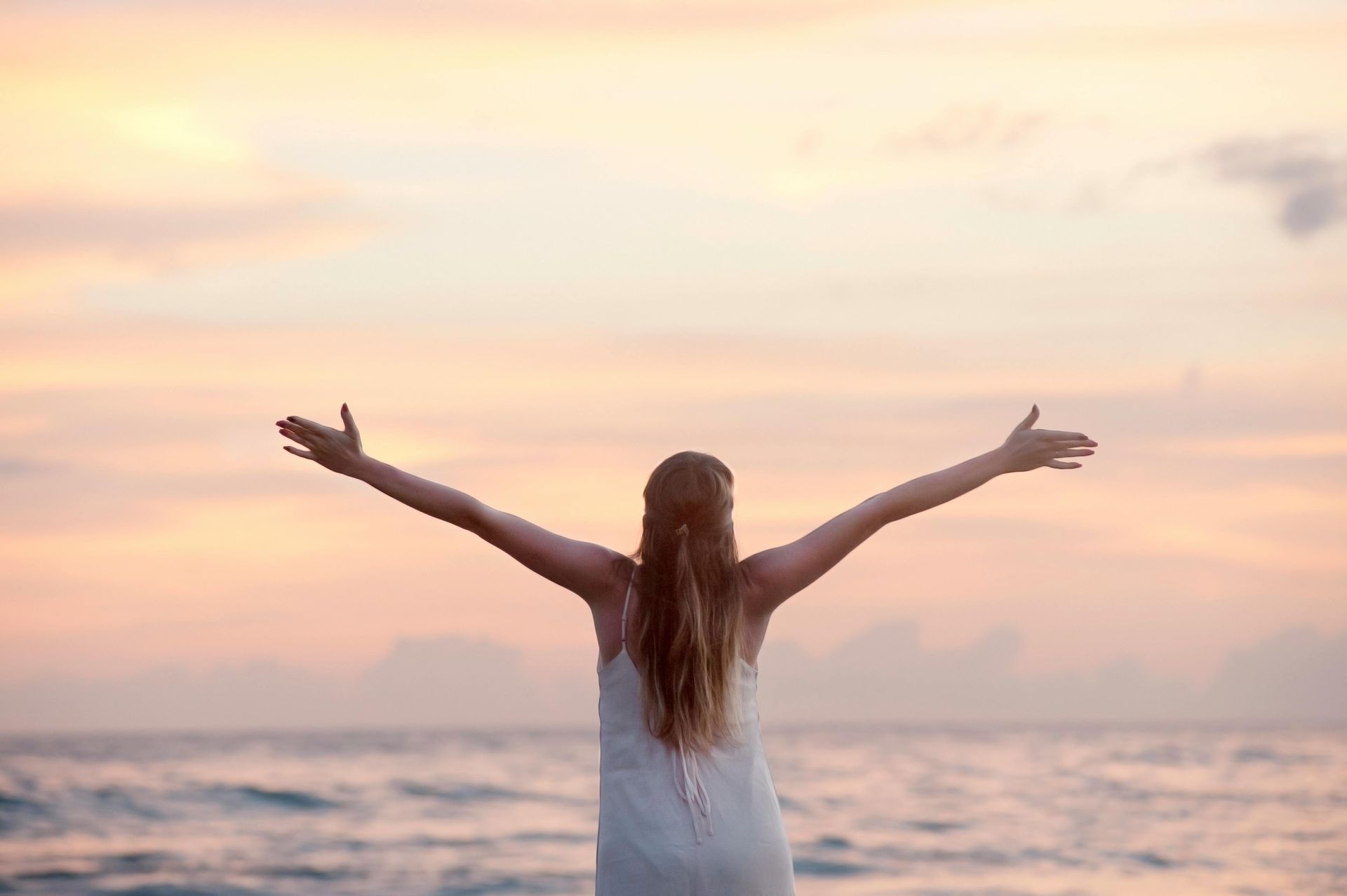 Woman With Arms Outstretched Towards the Ocean — Eastcoast Women's Centre in Nambour, QLD