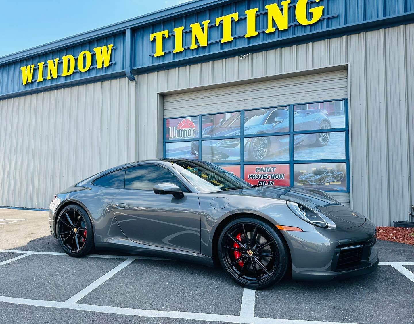 Gray Porsche 911 parked outside with windows tinted by Window Kote of Largo