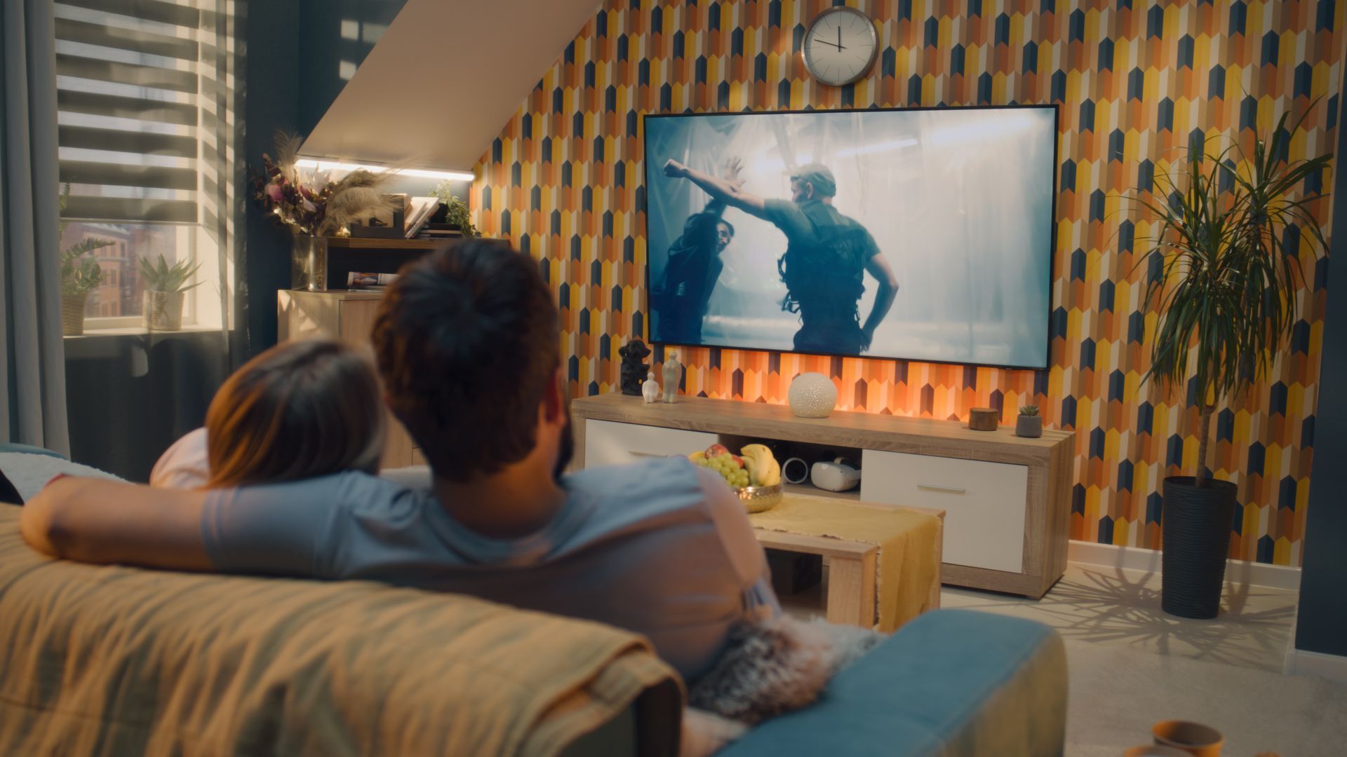A couple watching TV in a cozy living room. A couple watching TV in a cozy living room.