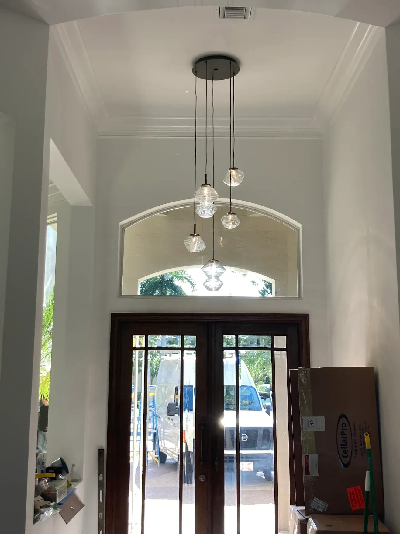 A hallway with a ceiling light hanging from it