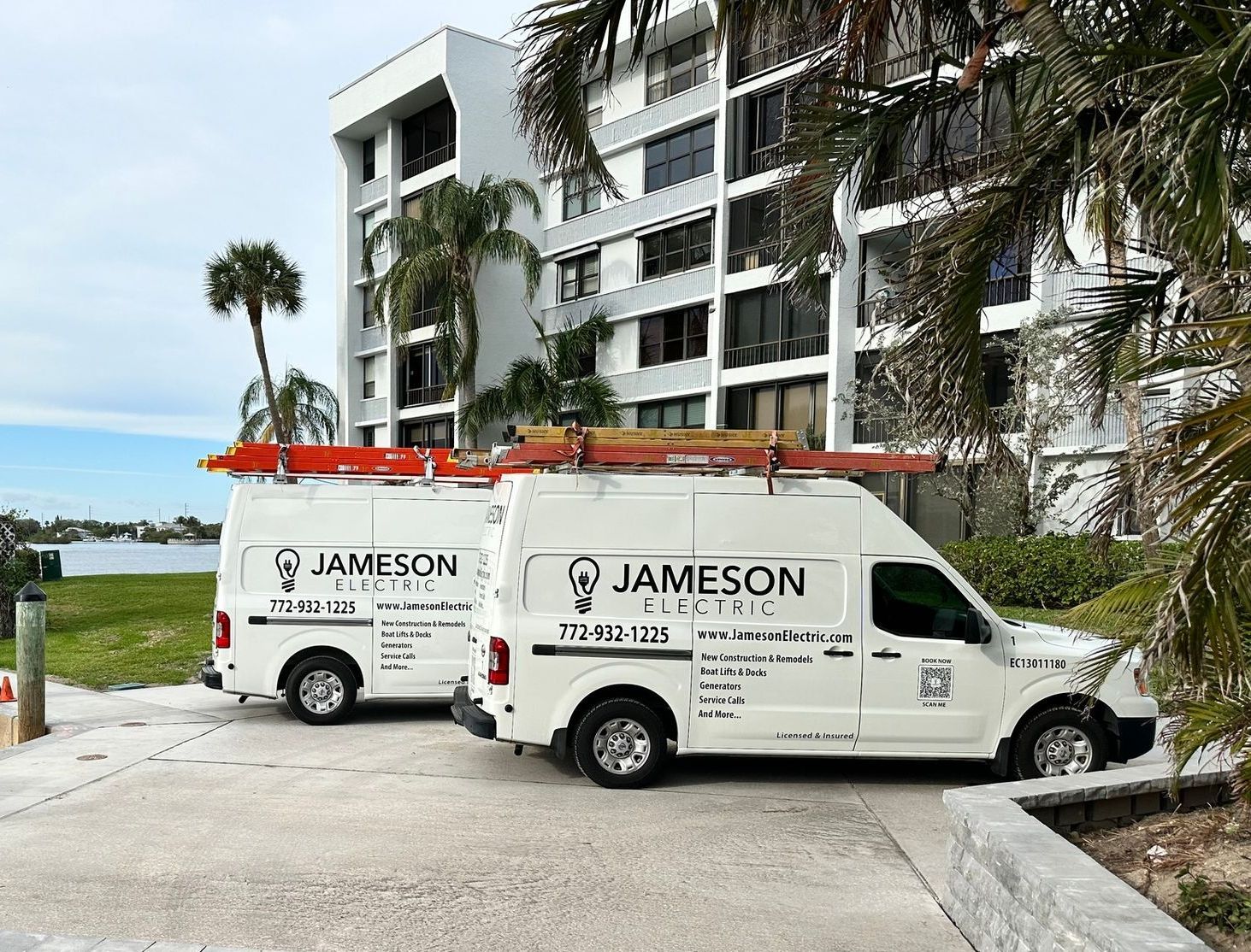 Two jameson vans are parked in front of a building.