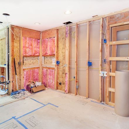 A room that is being remodeled with insulation on the walls.