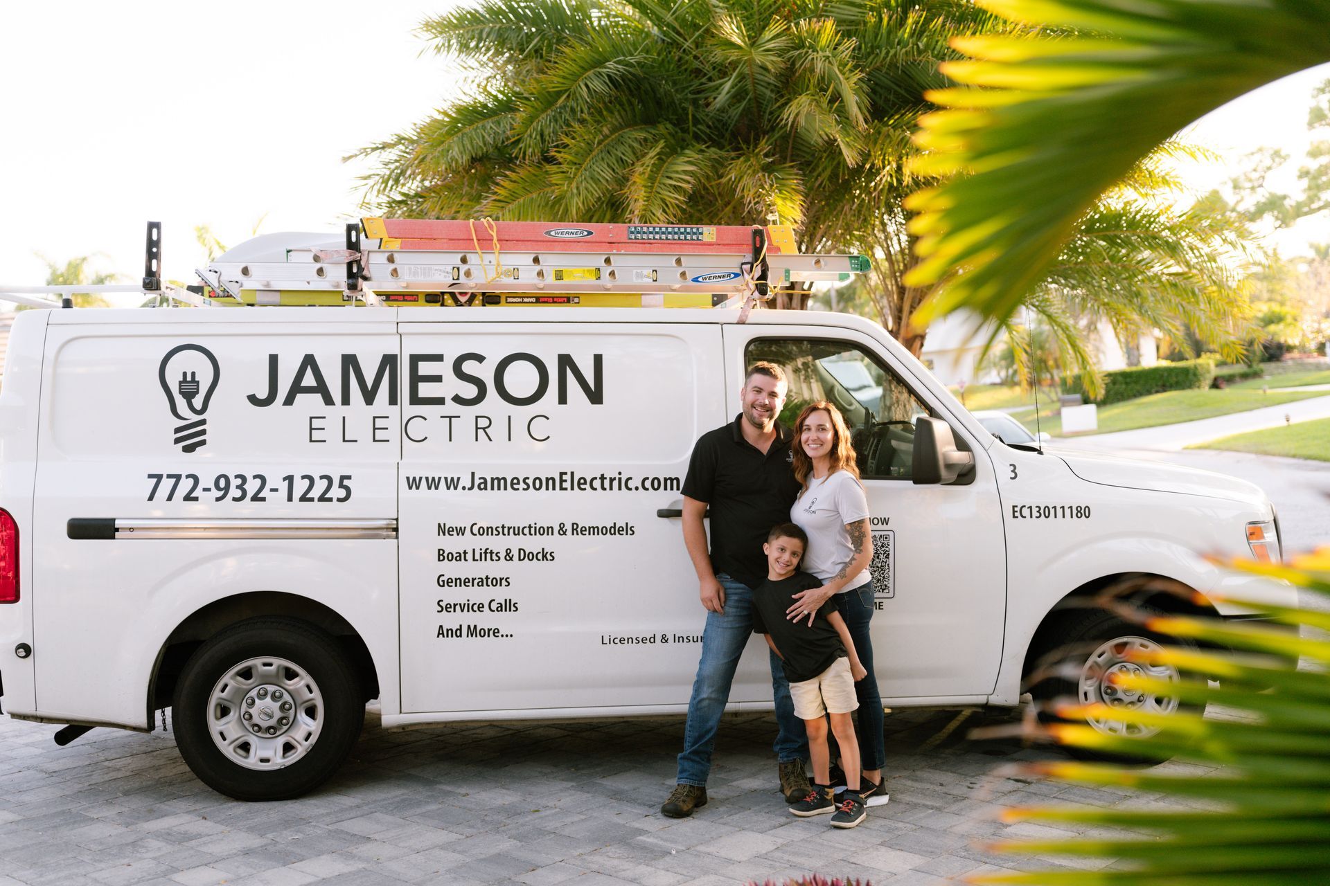 Two jameson vans are parked in a driveway in front of a building.
