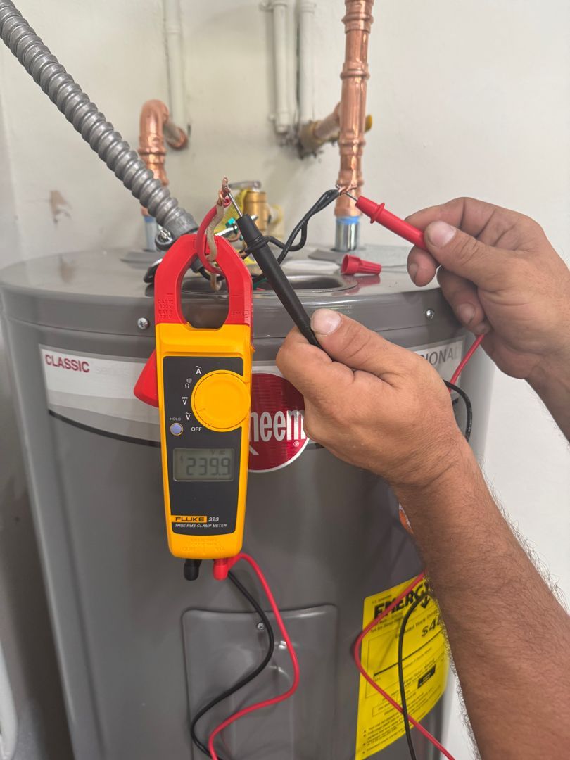 A man is using a clamp meter to test a water heater