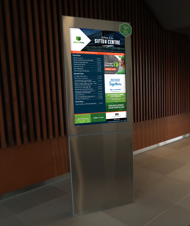 Digital information kiosk with a green-topped screen in a hallway against a wood slat wall.